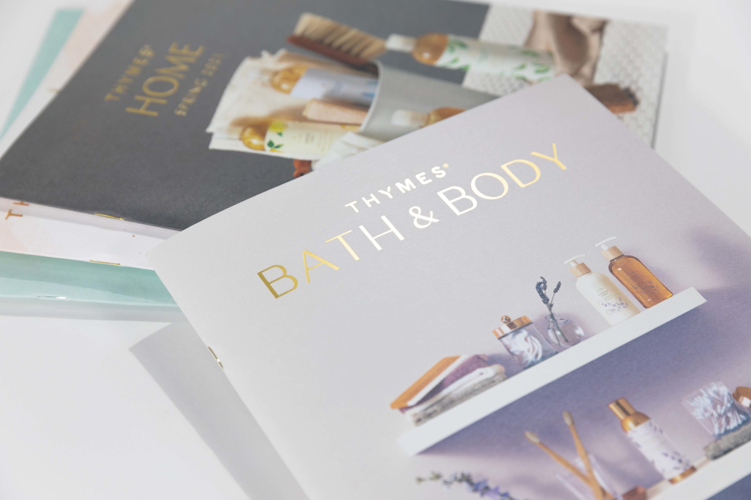 Thymes bath and body catalog with gold foil and saddle stiching